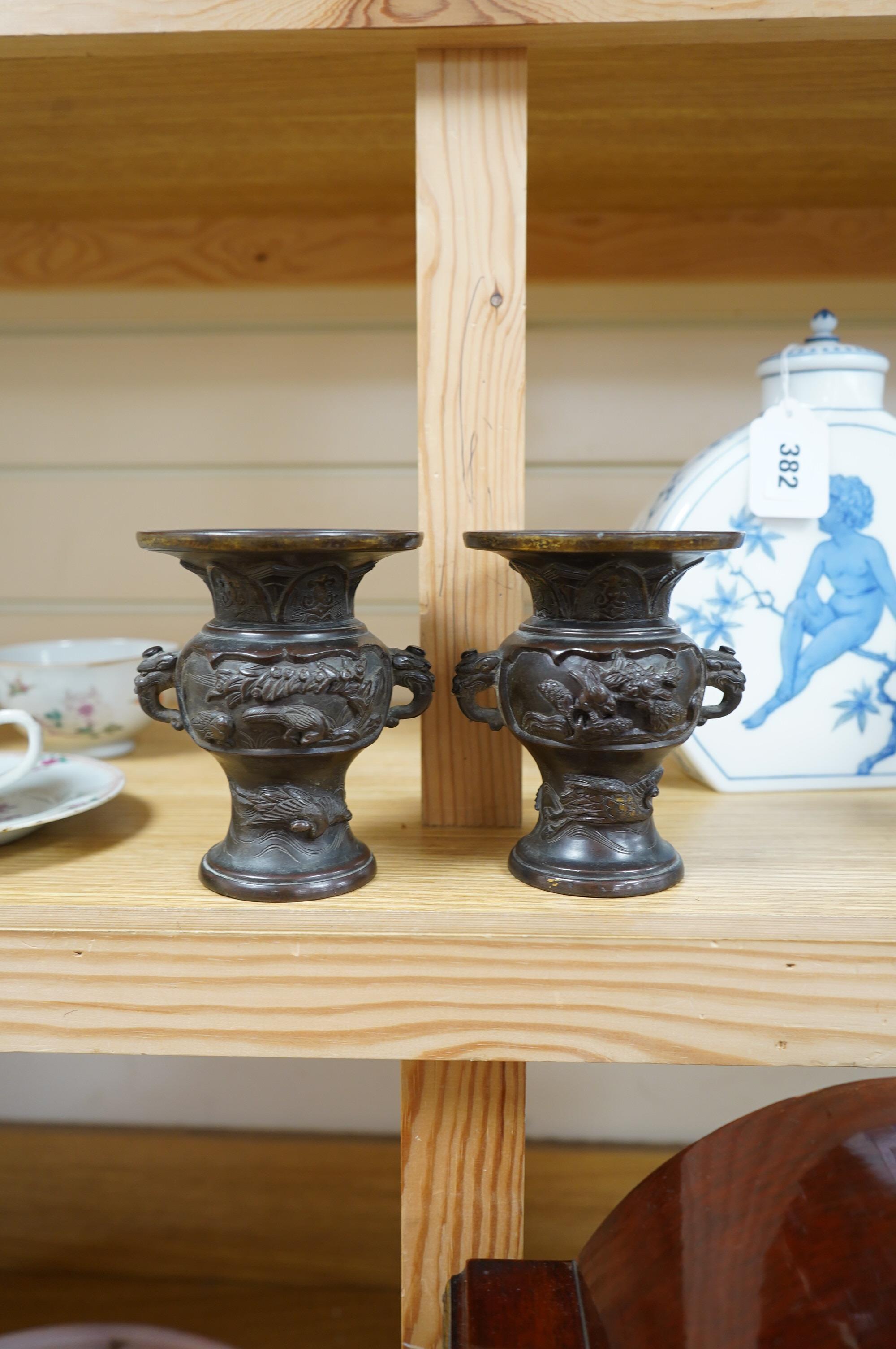 A pair of Japanese bronze vases, Meiji period, one signed, one lacking base, 13cm. Condition - fair